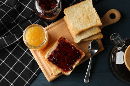 Toasts, jam and tea on wooden background, top viewの写真素材