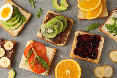 Delicious assorted sandwiches on grey background, top viewの写真素材