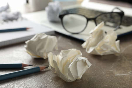 Workplace. Paper balls on grey table, close upの写真素材