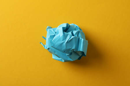 Paper ball on yellow background, close upの写真素材