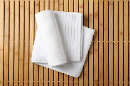 White fresh towels on bamboo background, top viewの写真素材