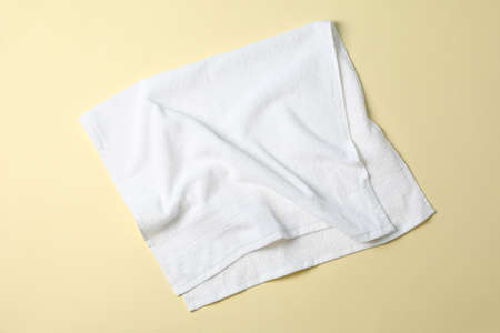 Fresh white towel on beige background, top viewの写真素材