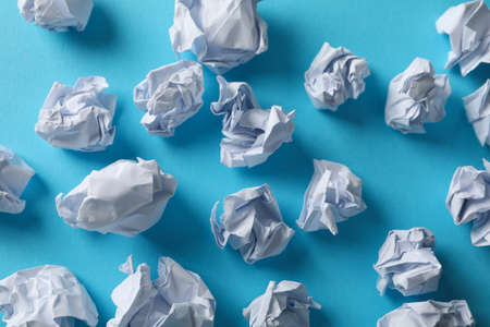 Paper balls on blue texture background, close upの写真素材
