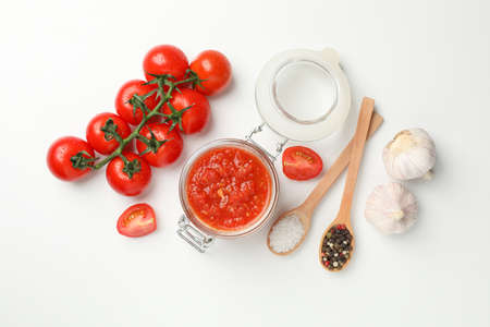 Chili sauce in glass jar and ingredients on white background, space for text. Top viewの写真素材