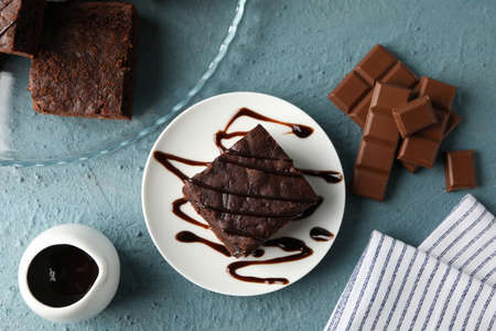 Composition with chocolate cake slices on blue background, top view