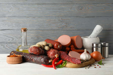 Sausage, spice and board on wooden background, space for textの写真素材