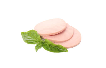 Boiled sausage slices and basil isolated on white backgroundの写真素材