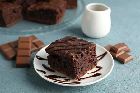 Composition with chocolate cake slices on blue background, close up
