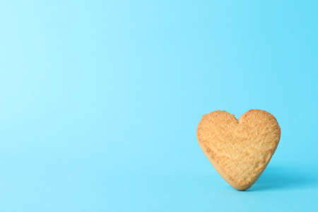 Heart shaped cookie on blue background, close upの写真素材