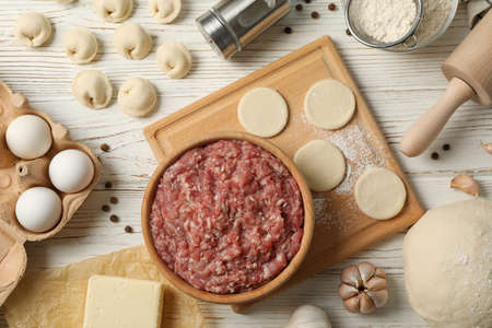 Composition with minced meat and dumplings on wooden background, top viewの写真素材