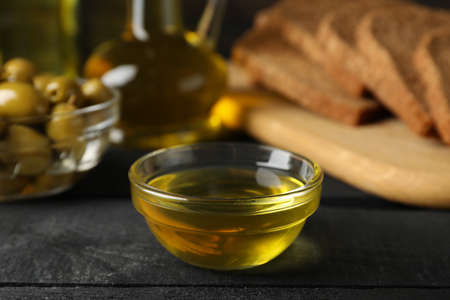Composition with olive oil, bread and olives on wooden background, close upの写真素材