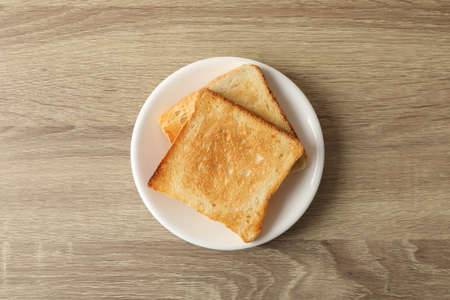Plate with toasts on wooden background, top viewの写真素材
