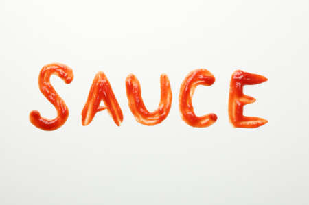 Inscription SAUCE made of sauce on white background, top viewの写真素材