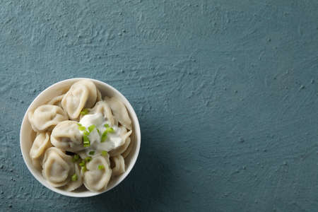 Bowl with dumplings on blue background, top viewの写真素材