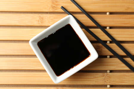 Soy sauce on wooden background, space for text. Top viewの写真素材