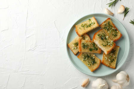 Plate with toasted garlic bread on white background, top viewの写真素材