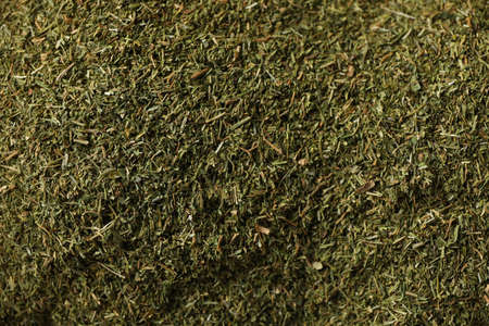 Dried dill powder texture background, close up