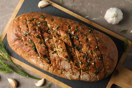 Board with garlic bread and spices on grey background, top viewの写真素材