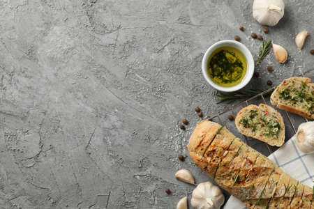 Tasty garlic bread and spices on grey background, top viewの写真素材