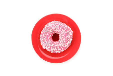 Tasty pink donut on red plate isolated on white backgroundの写真素材