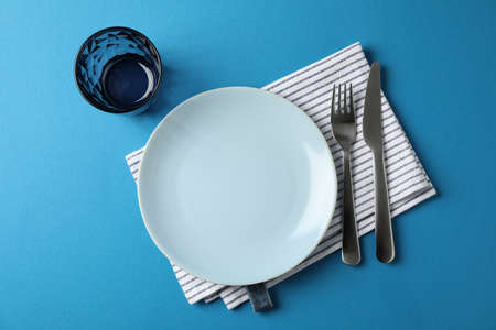 Table setting on blue background, top viewの写真素材