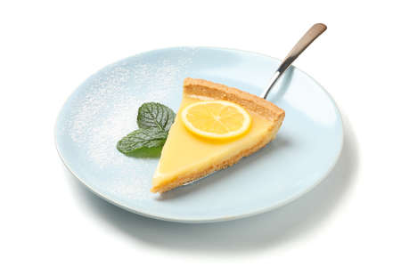 Plate with lemon tart slice and mint isolated on white backgroundの写真素材