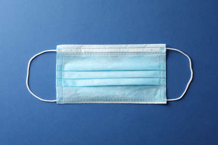 Protective mask on blue background, top view, space for text.の写真素材