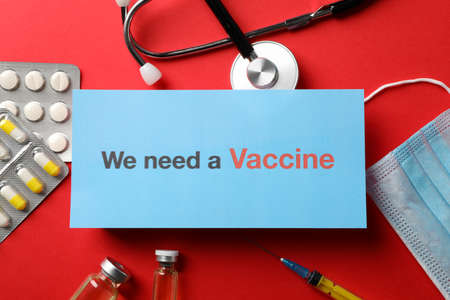 Inscription We need a vaccine on red background with medical composition. Healthcare and medical conceptの写真素材