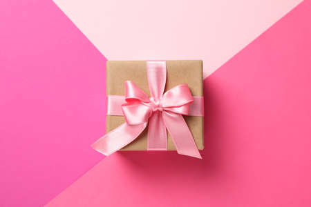 Gift box on multicolor background, top view