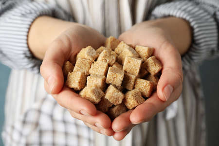 Woman holding sugar cubes in hands, close upの写真素材