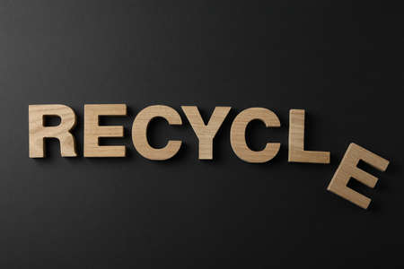 Word Recycle made of wooden letters on black background, top viewの写真素材
