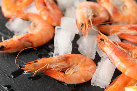 Delicious shrimps and ice on black background, close upの写真素材