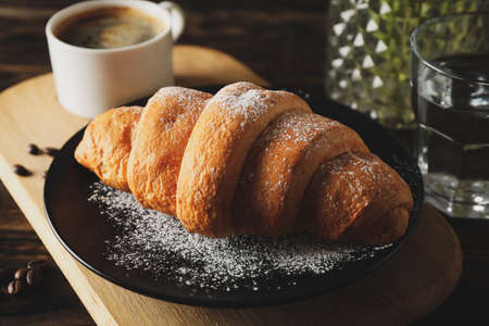 Composition with delicious croissant on wooden background, close upの写真素材
