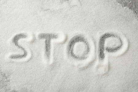 Inscription Stop made of sugar on grey background, top viewの写真素材