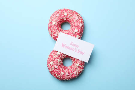 Eight made of donuts on blue background, top viewの写真素材