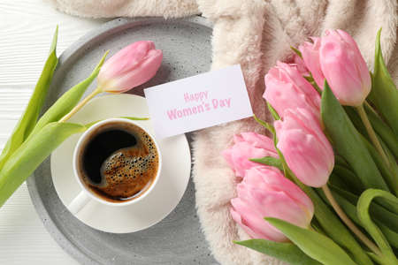 Composition with pink tulips on white wooden background, top view