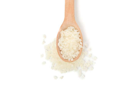 Wooden spoon with rice isolated on white background, close upの写真素材