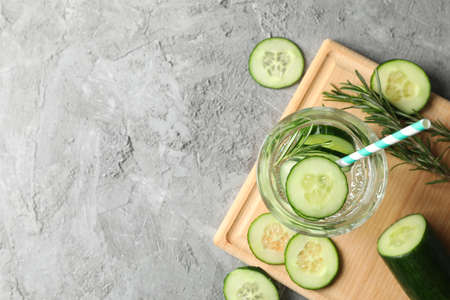Composition with glass of cucumber water on grey background, top viewの写真素材