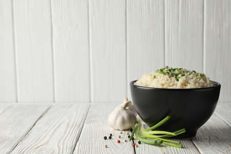 Composition with bowl of delicious rice on wooden background, copy spaceの写真素材