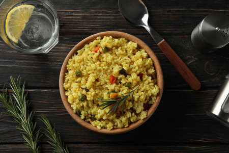 Composition with bowl of delicious rice on wooden background, top viewの写真素材