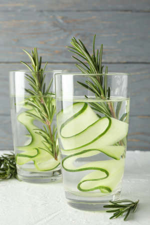 Glasses with cucumber water on white table, close upの写真素材