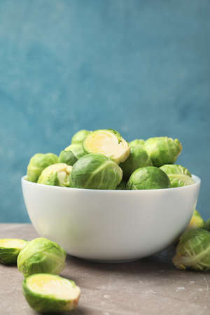 Bowl with brussels sprout on grey table, space for textの写真素材