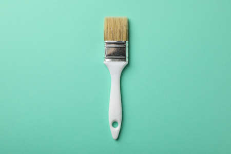 Paint brush on green background, space for text