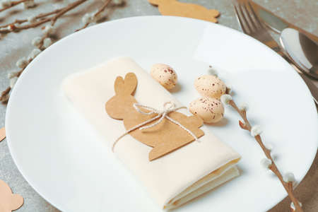 Easter table setting on grey background, close up
