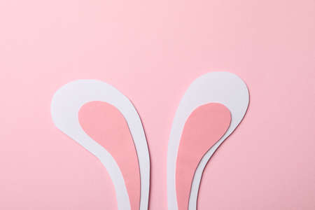 Decorative bunny ears on pink background, space for text