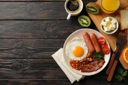 Delicious breakfast or lunch with fried eggs on wooden background, top viewの写真素材