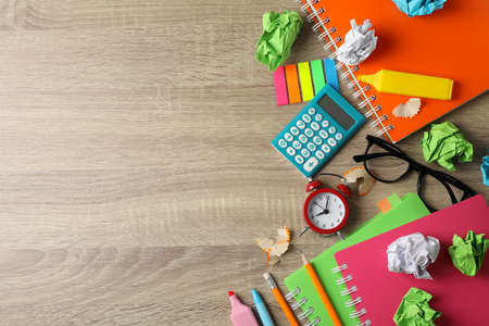 Frame of different stationary on wooden background, top view