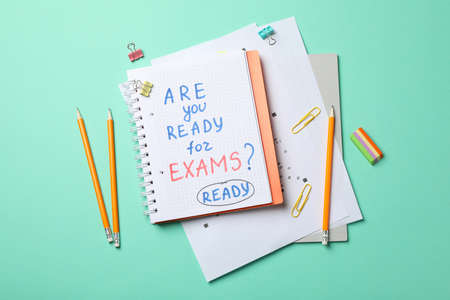 Inscription Are you ready for exams? Ready and stationary on mint background, top viewの写真素材