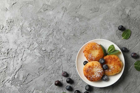 Breakfast of cheese pancakes on grey background, top viewの写真素材