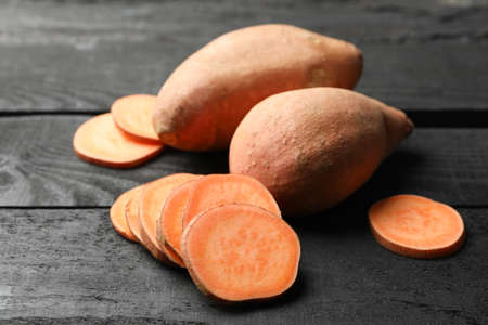 Sweet potato on wooden background, close up. Vegetablesの写真素材